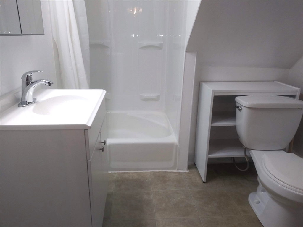 43 Glenwood Avenue, Unit 1 Boston, MA 02136 - Photo 11 of 11 a bathroom with a toilet sink and a bathtub