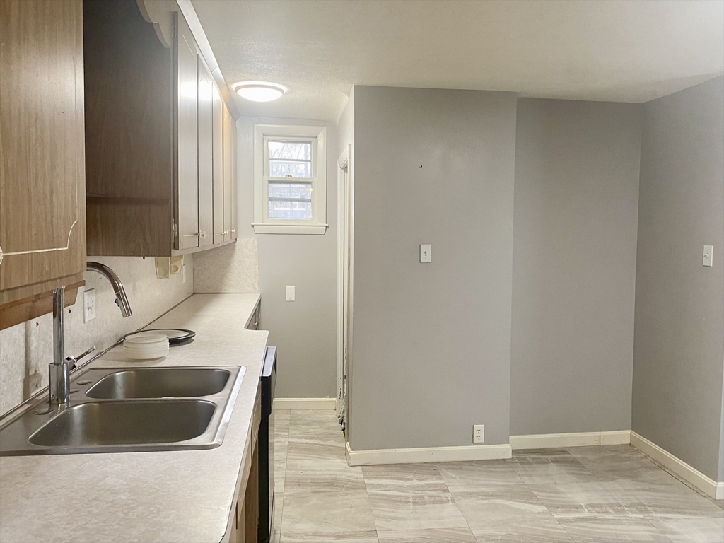 43 Glenwood Avenue, Unit 1 Boston, MA 02136 - Photo 7 of 11 a bathroom with a sink and a mirror