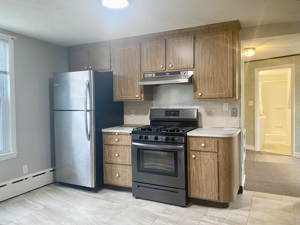 43 Glenwood Avenue, Unit 1 Boston, MA 02136 - Photo 8 of 11 a kitchen with a stove and a refrigerator