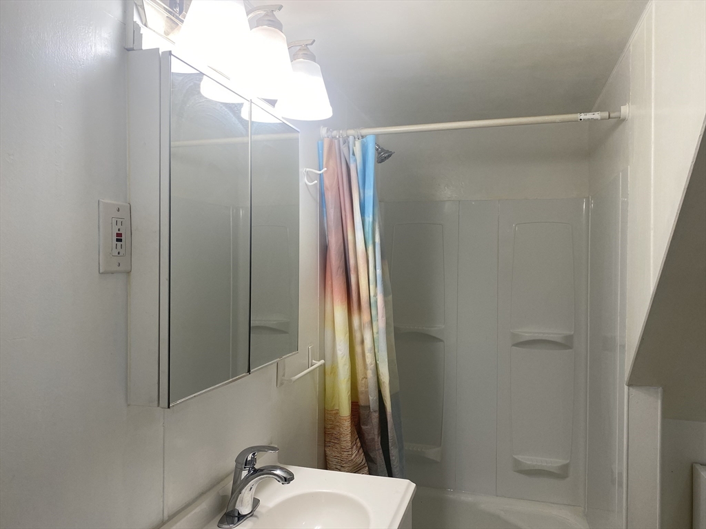 43 Glenwood Avenue, Unit 1 Boston, MA 02136 - Photo 10 of 11 a bathroom with a shower and a sink