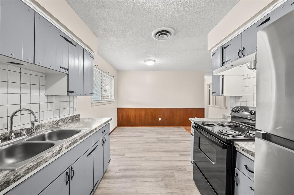 404 Vaden Avenue Everman, TX 76140 - Photo 8 of 16 a kitchen that has a sink and a stove