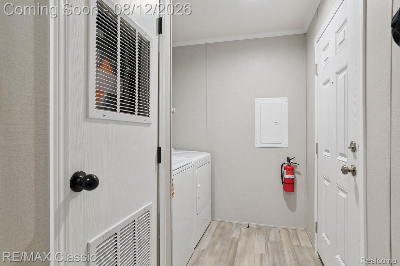 7105 West Vienna Road Clio, MI 48420 - Photo 20 of 23 Utility space featuring wood-finish flooring and a white paneled door