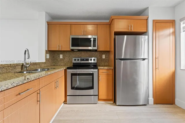 a kitchen with a refrigerator sink and microwave