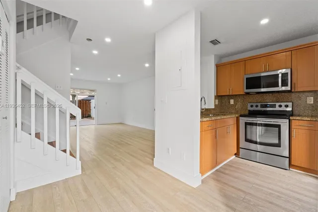 a view of kitchen with microwave and stove