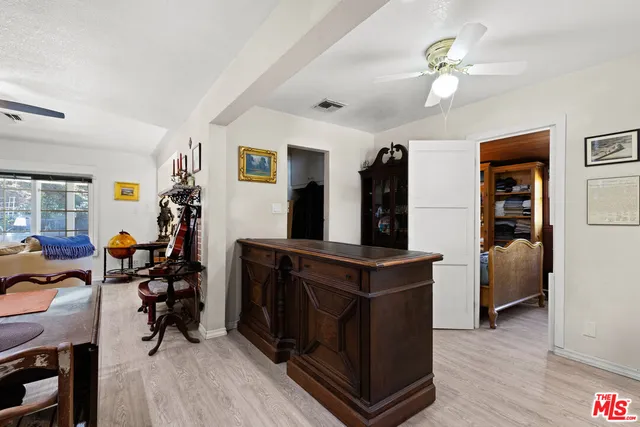 a view of a workspace with furniture and wooden floor