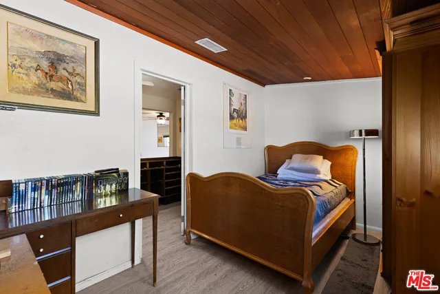 a living room with a bed furniture and a window
