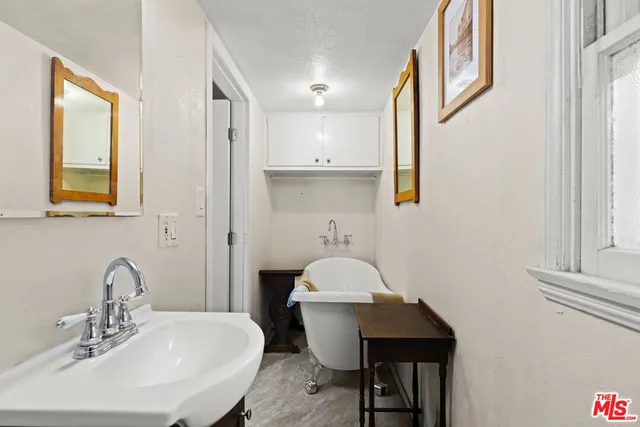 a bathroom with a toilet a sink and a mirror