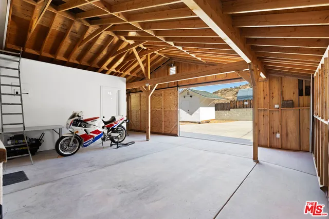a view of a garage with the table and chairs