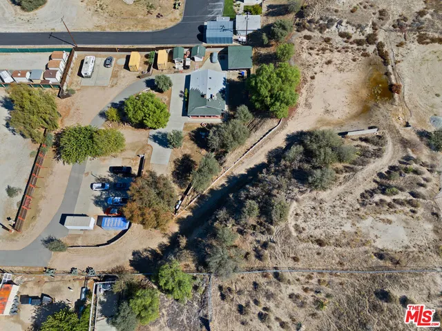 an aerial view of a house with a yard and mountain view