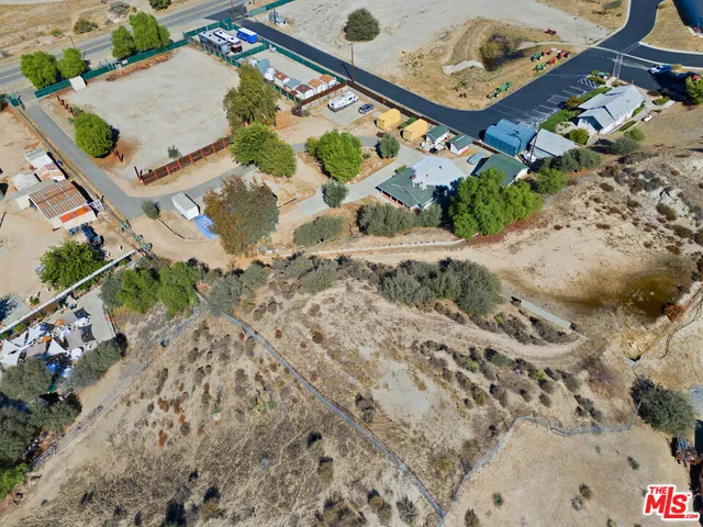 an aerial view of multiple houses with yard