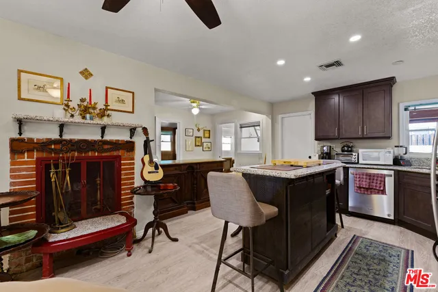 a kitchen with stainless steel appliances granite countertop a stove a sink dishwasher and a refrigerator