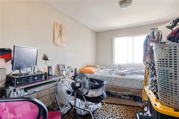 a bedroom with furniture and a window