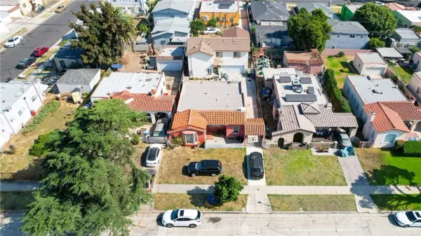 an aerial view of multiple houses with yard