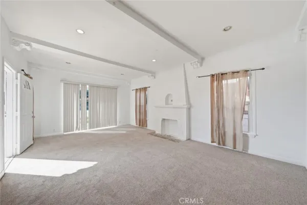 a view of an empty room with a fireplace