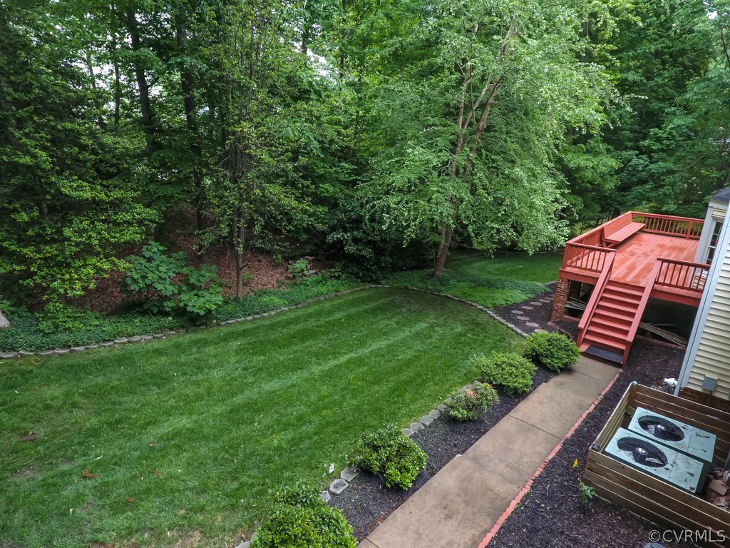 13900 Beechwood Point Road Midlothian, VA 23112 - Photo 3 of 34 a view of a backyard with plants and a garden