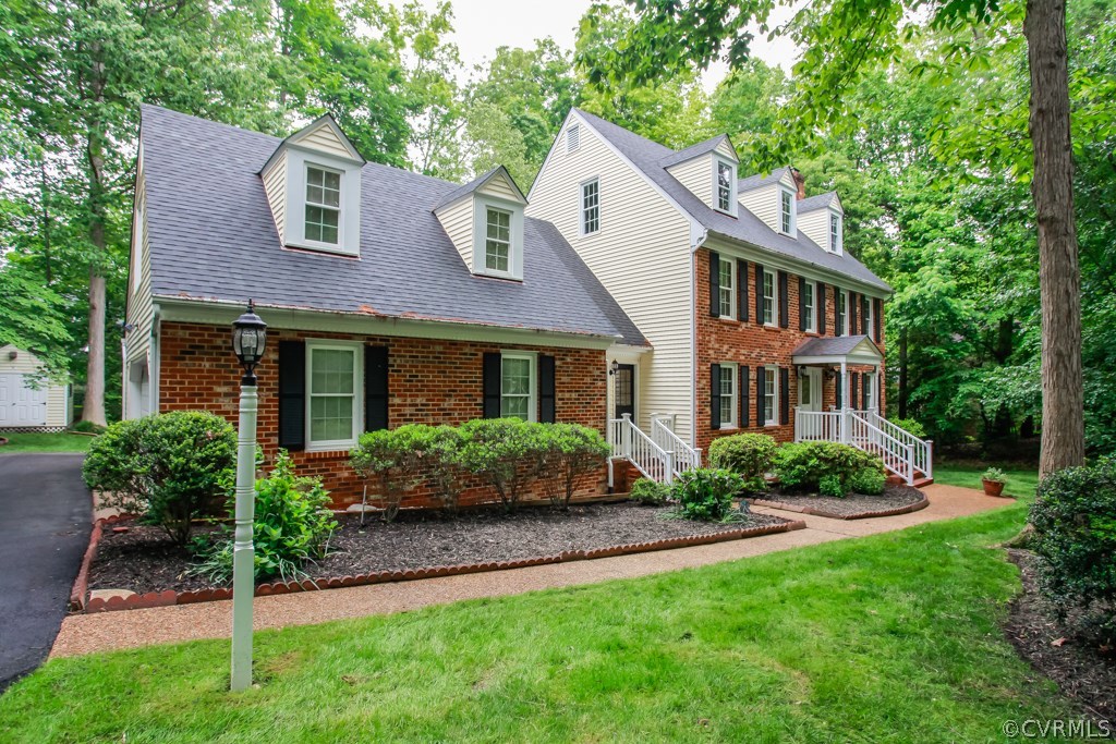 13900 Beechwood Point Road Midlothian, VA 23112 - Photo 33 of 34 a front view of a house with a yard and potted plants