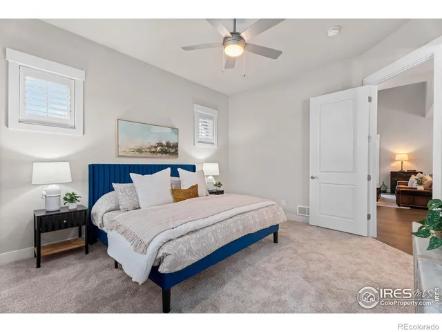 a spacious bedroom with a bed and a chandelier