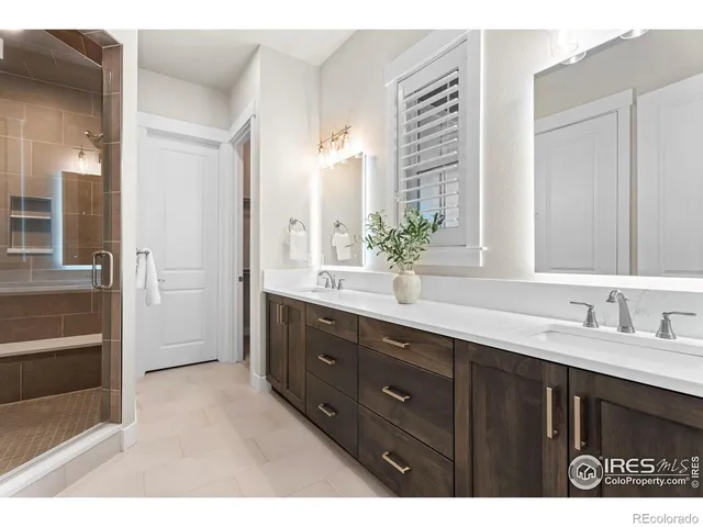 a bathroom with a sink double vanity and a mirror