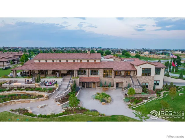 an aerial view of a house with a garden and lake view