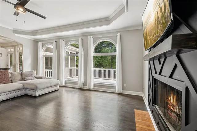 a kitchen with stainless steel appliances granite countertop a refrigerator a stove top oven a sink dishwasher and white cabinets with wooden floor