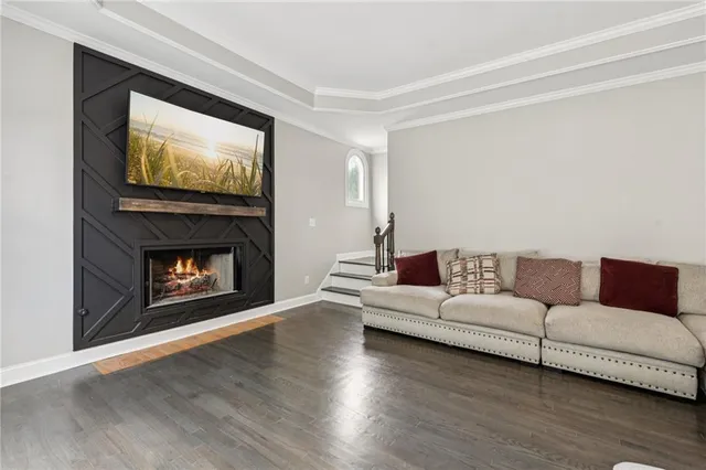 a kitchen with stainless steel appliances granite countertop a sink and dishwasher a stove top oven with wooden floor