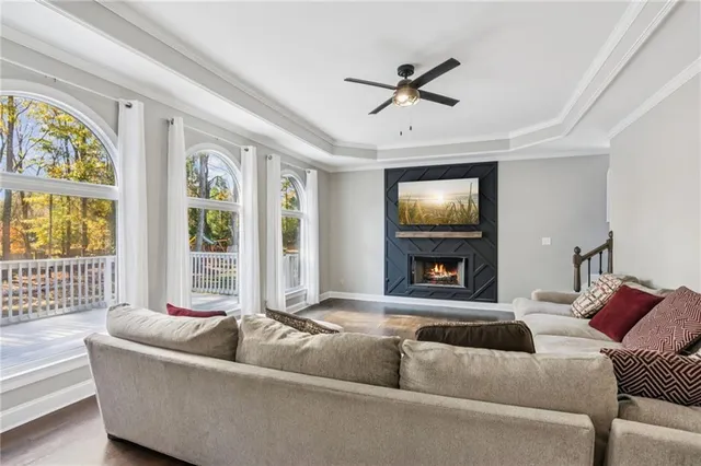 a kitchen with granite countertop white cabinets and wooden floor