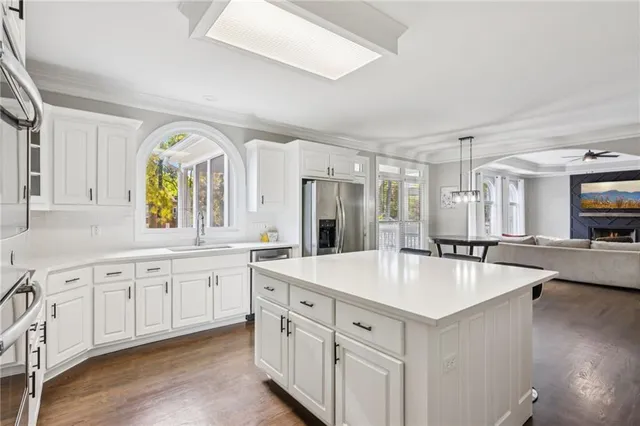 a view of a livingroom with an empty space and a window