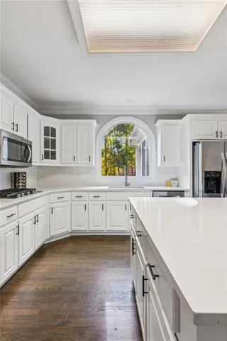 a bathroom with a sink toilet and a mirror