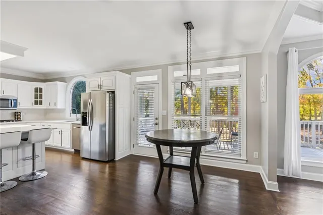 a view of a kitchen with a sink and a refrigerator