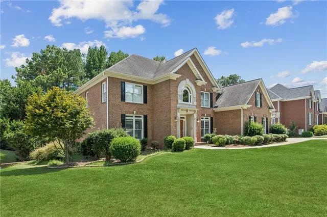 a front view of a house with a yard