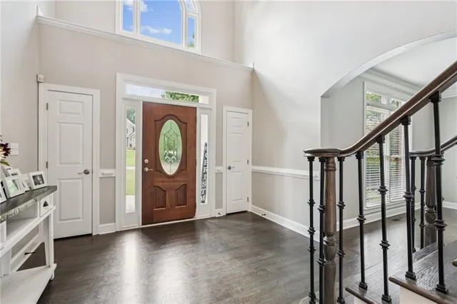 a living room with furniture white walls and wooden floor