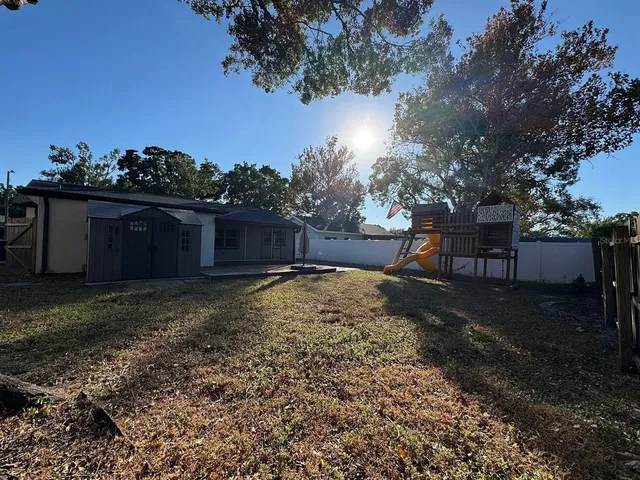 a view of a backyard with large trees