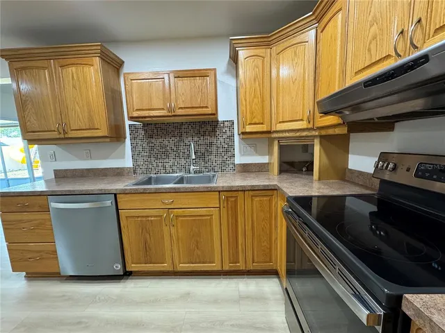 a kitchen with granite countertop cabinets and black stainless steel appliances
