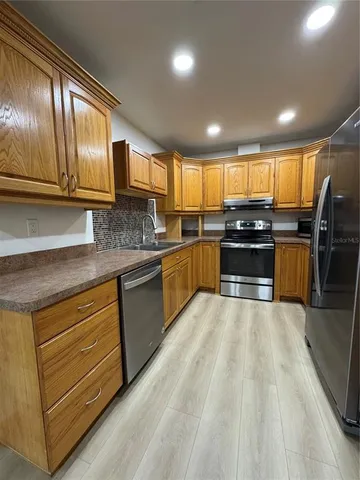 a kitchen with stainless steel appliances granite countertop a stove and cabinets
