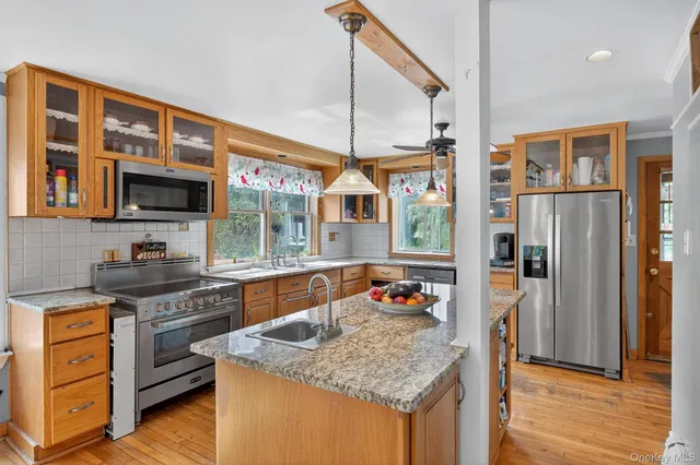a kitchen with stainless steel appliances granite countertop a stove and a sink