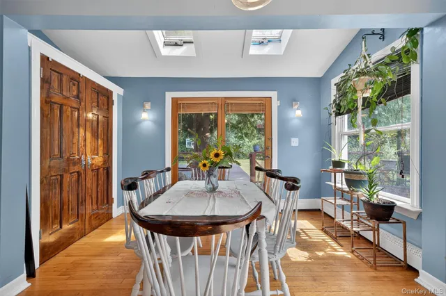 a dining room with furniture and a window