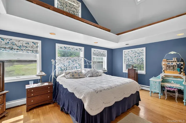 a bed sitting in a bedroom next to a window