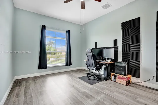 a view of a workspace with furniture and a flat screen tv