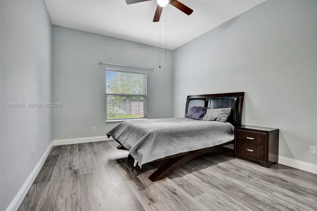 a bedroom with a bed and a ceiling fan