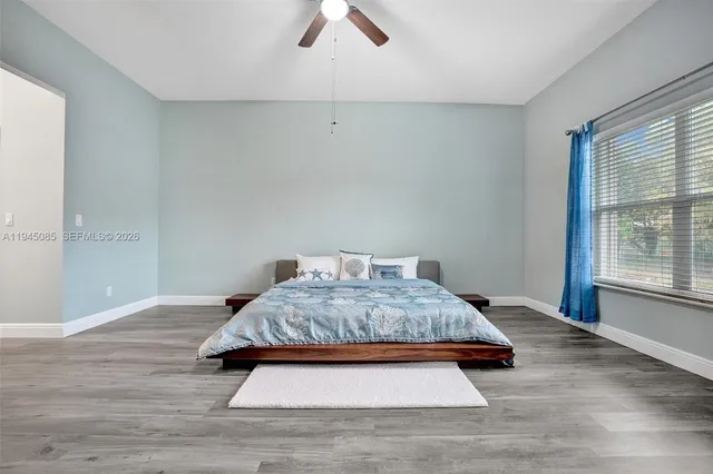 a spacious bedroom with a bed and a window