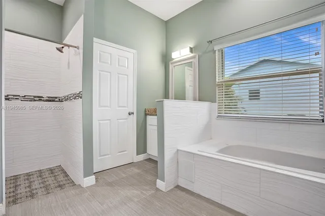 a bathroom with a bathtub and a shower