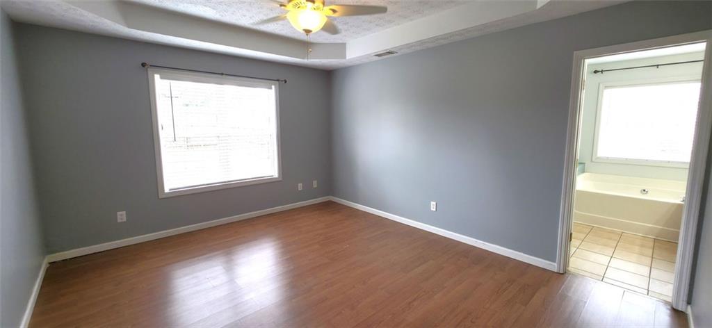 89 Savannah Lane Jefferson, GA 30549 - Photo 5 of 19 an empty room with wooden floor and windows