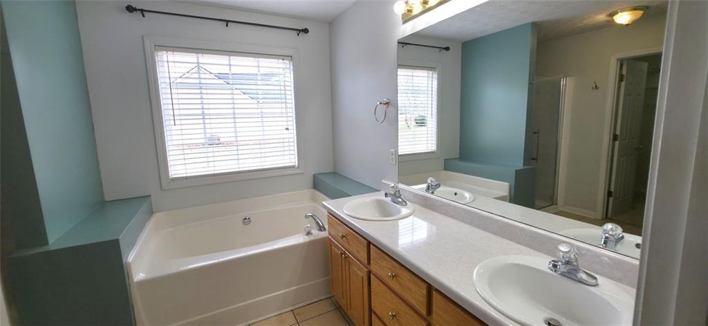 89 Savannah Lane Jefferson, GA 30549 - Photo 7 of 19 a bathroom with a tub sink double vanity granite and mirror