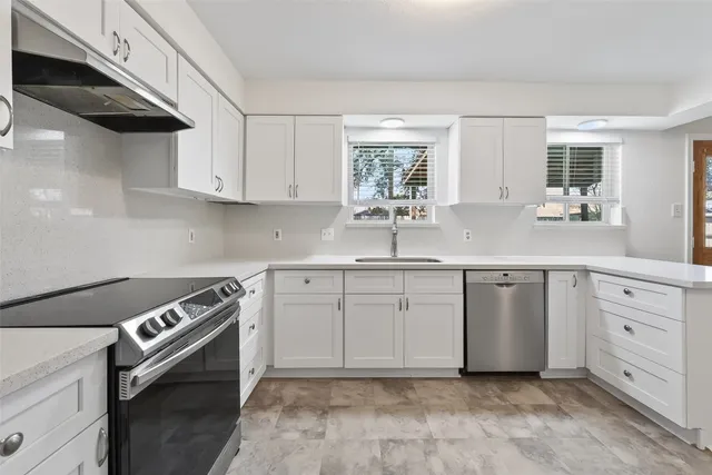 an empty room with wooden floor and a ceiling fan