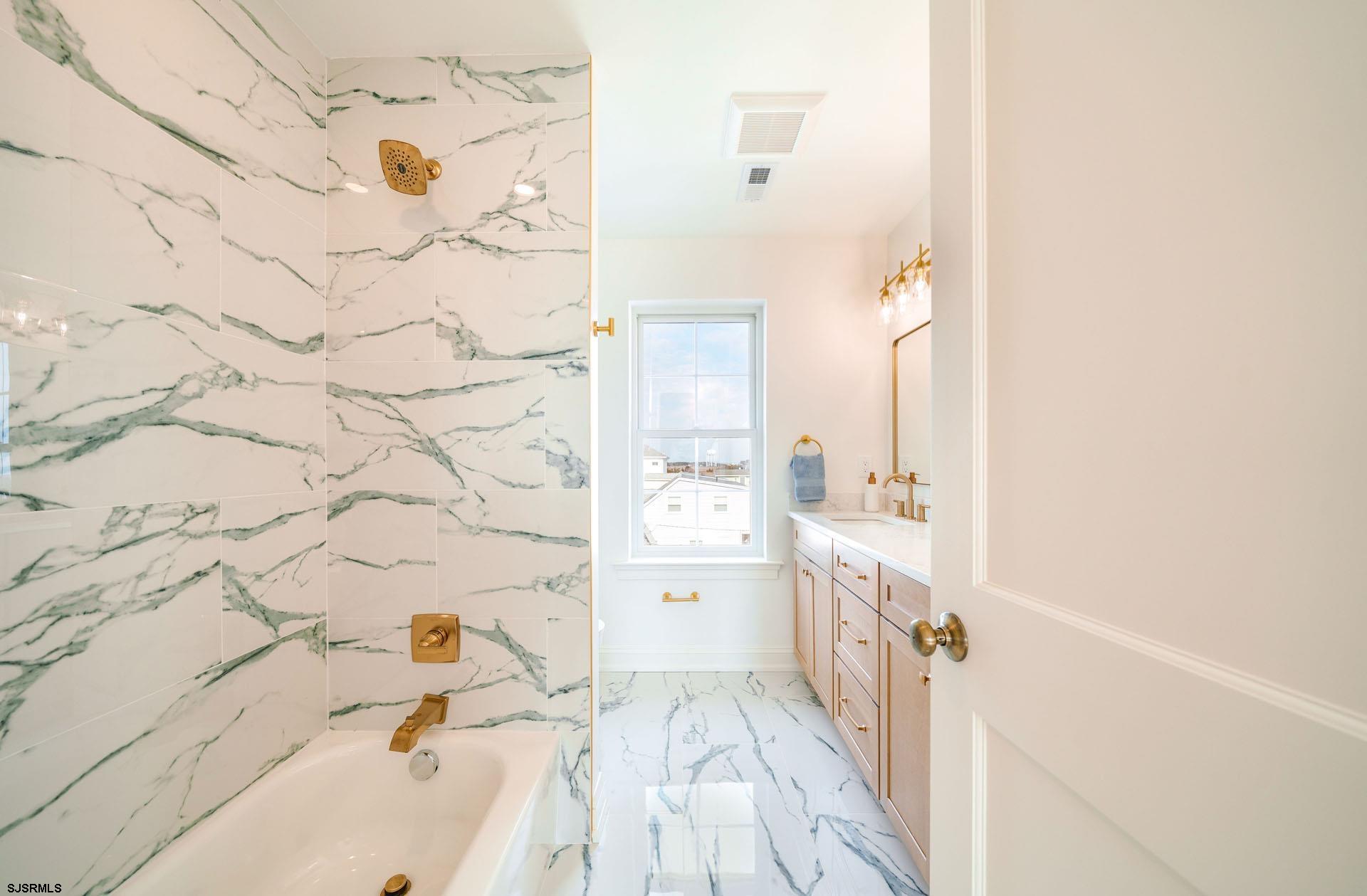 5217 Simpson Avenue Ocean City, NJ 08226 - Photo 21 of 52 a bathroom with a bathtub and a sink
