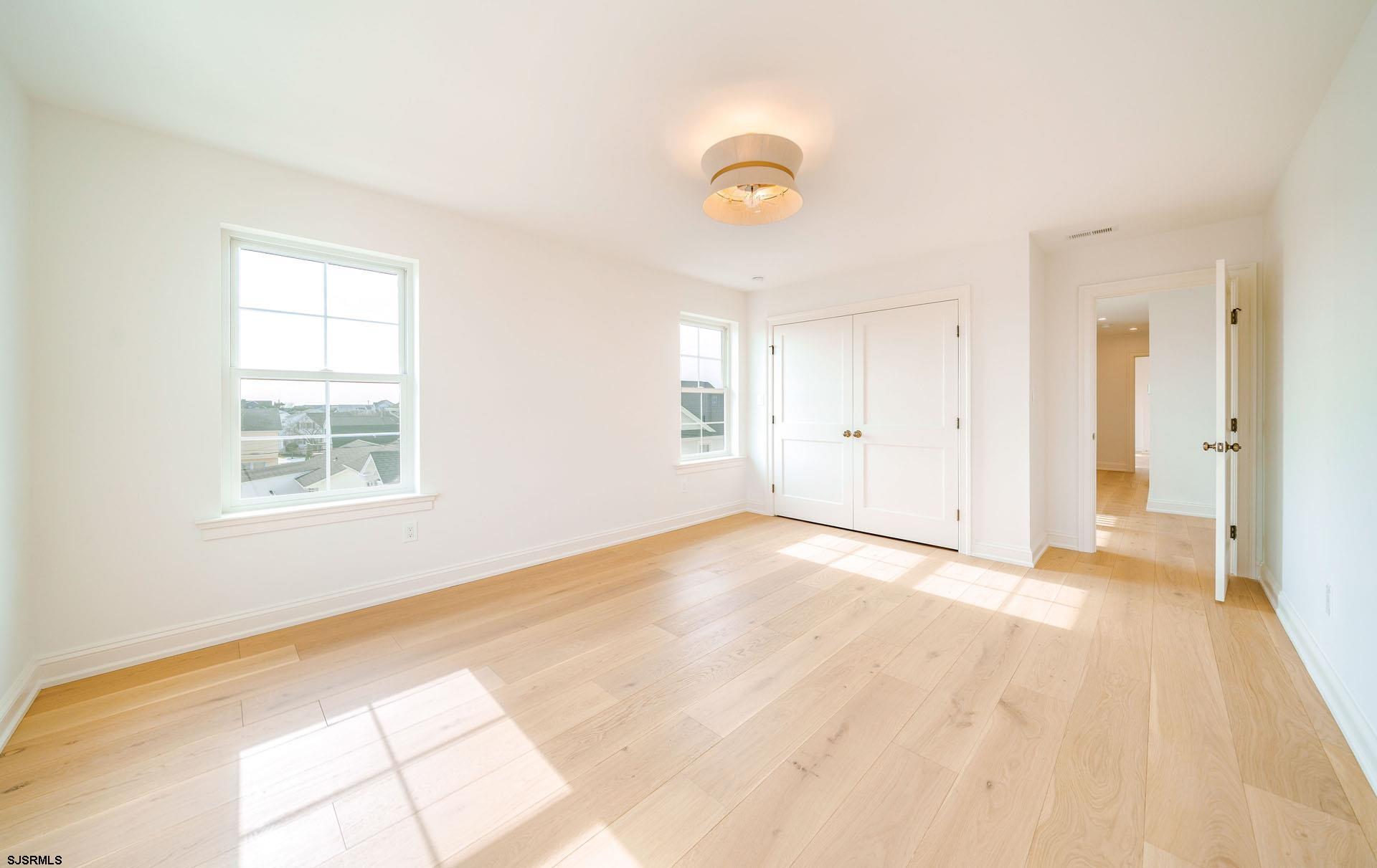 5217 Simpson Avenue Ocean City, NJ 08226 - Photo 26 of 52 a view of an empty room with wooden floor and a window