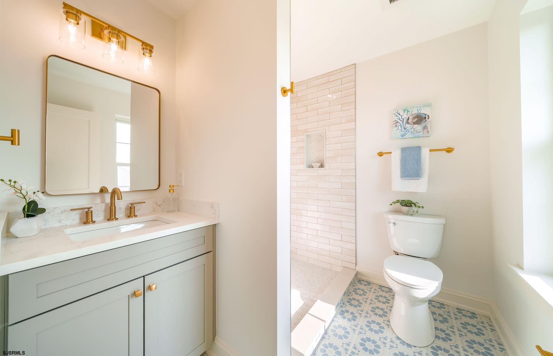 5217 Simpson Avenue Ocean City, NJ 08226 - Photo 29 of 52 a bathroom with a toilet sink and mirror