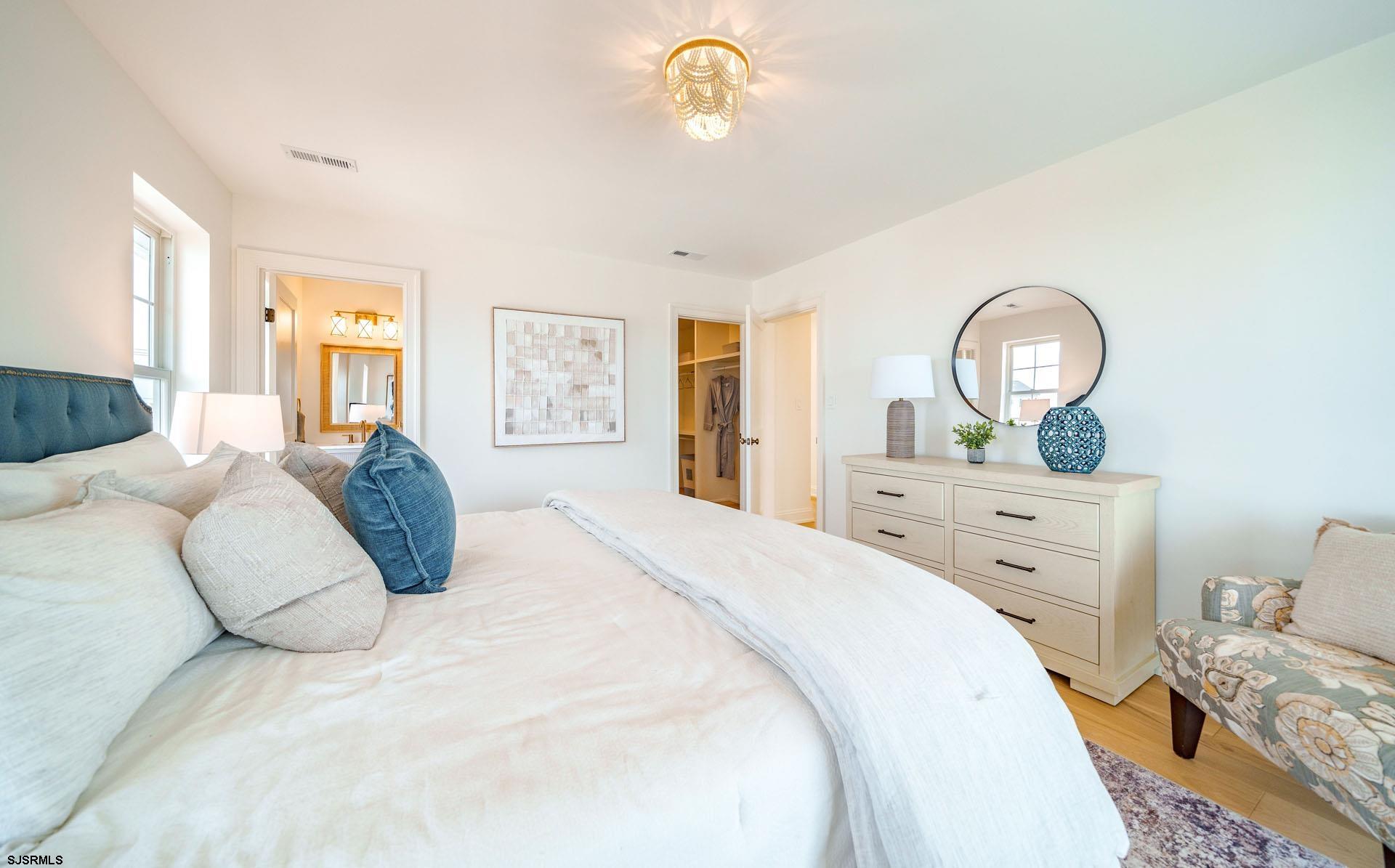 5217 Simpson Avenue Ocean City, NJ 08226 - Photo 34 of 52 a bedroom with a bed and a dresser