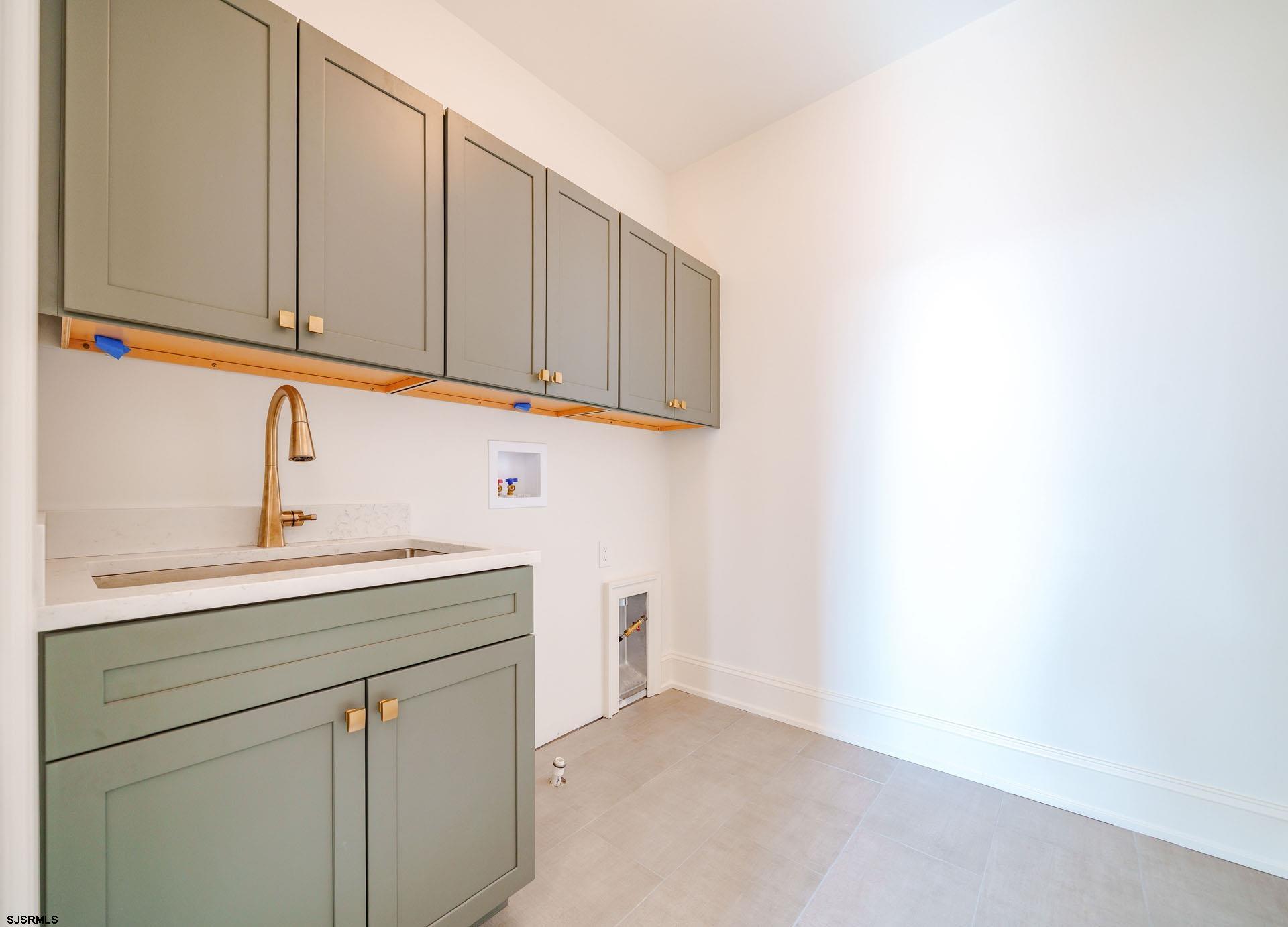 5217 Simpson Avenue Ocean City, NJ 08226 - Photo 41 of 52 a kitchen with a sink cabinets and a window