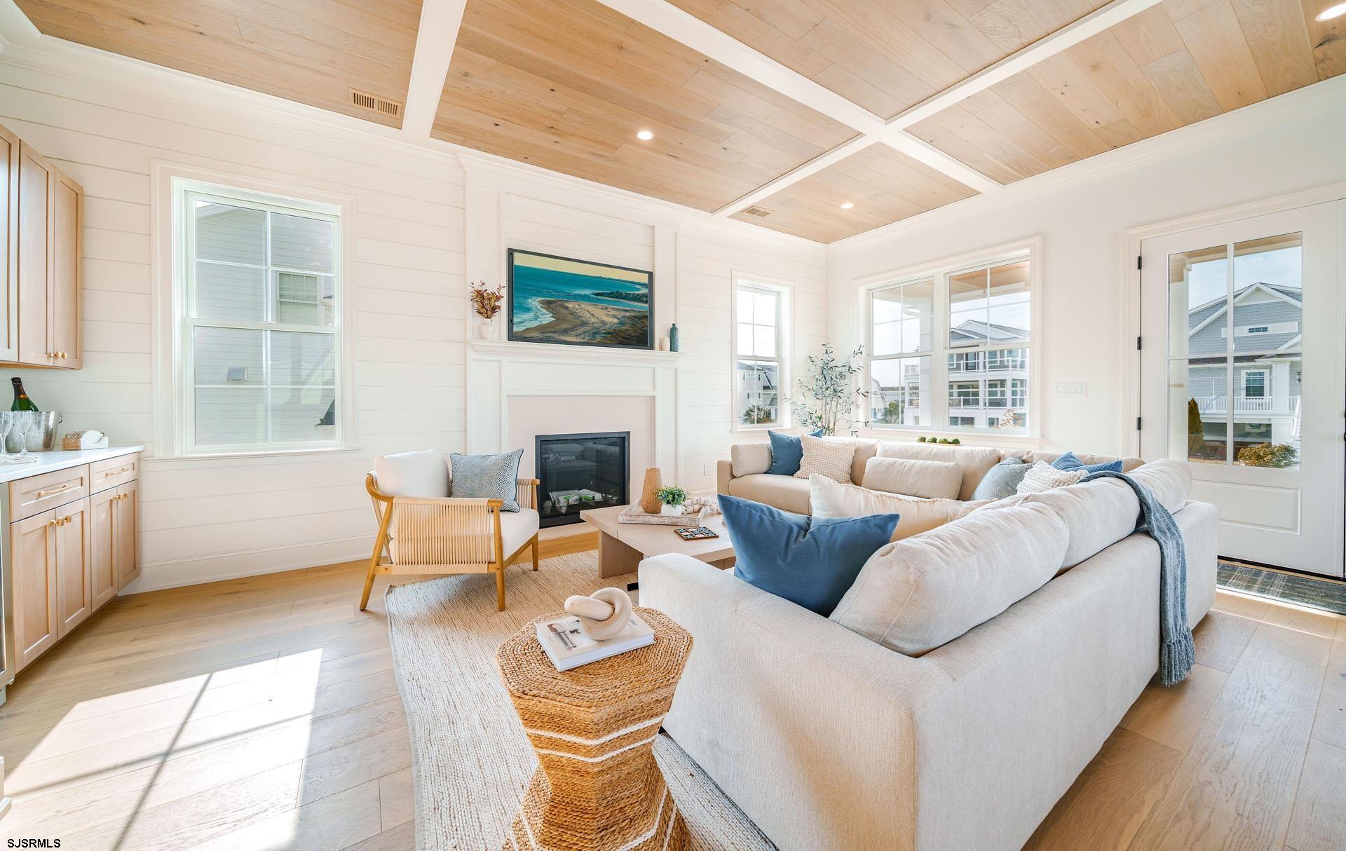 5217 Simpson Avenue Ocean City, NJ 08226 - Photo 5 of 52 a living room with furniture a large window and a fireplace